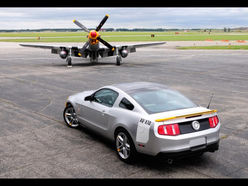 Silver Mustang and vintage plane