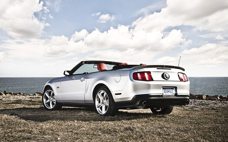 Silver Mustang convertible by the sea