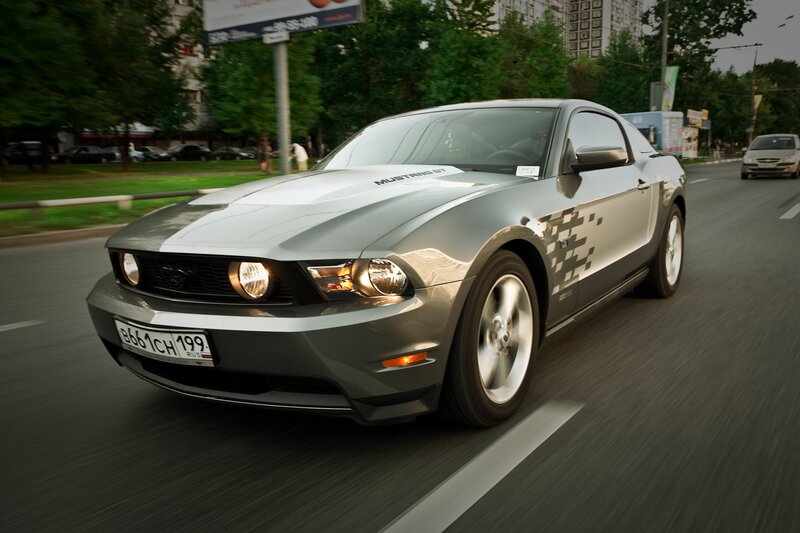 silver mustang driving on city street