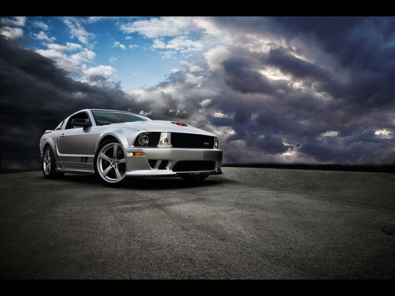 Silver Mustang on a stormy road