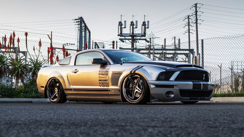 silver mustang on asphalt