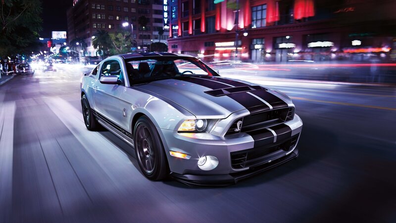 silver mustang on city street