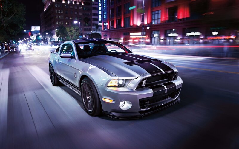 silver mustang on city street