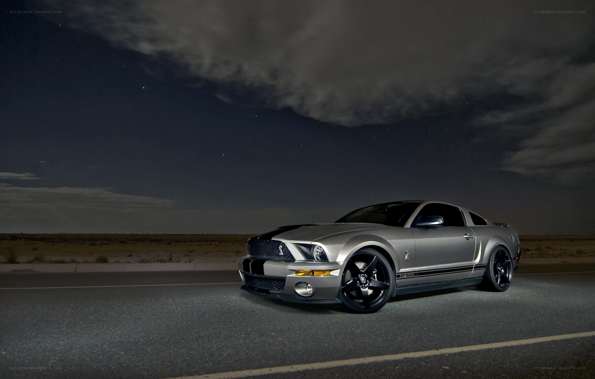 Silver Mustang on desert road