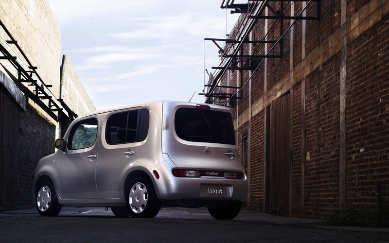 Silver Nissan Cube in alley