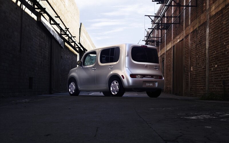 Silver Nissan Cube in alley