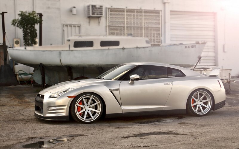 Silver Nissan GT-R with boat in background