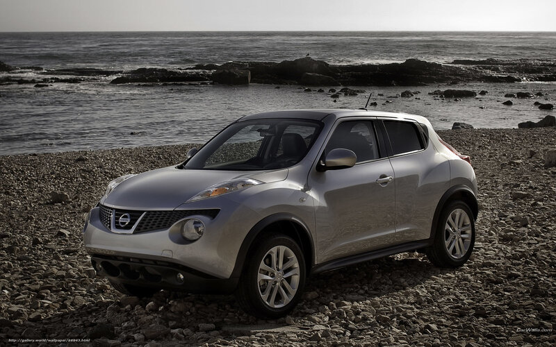 Silver Nissan Juke on a rocky beach