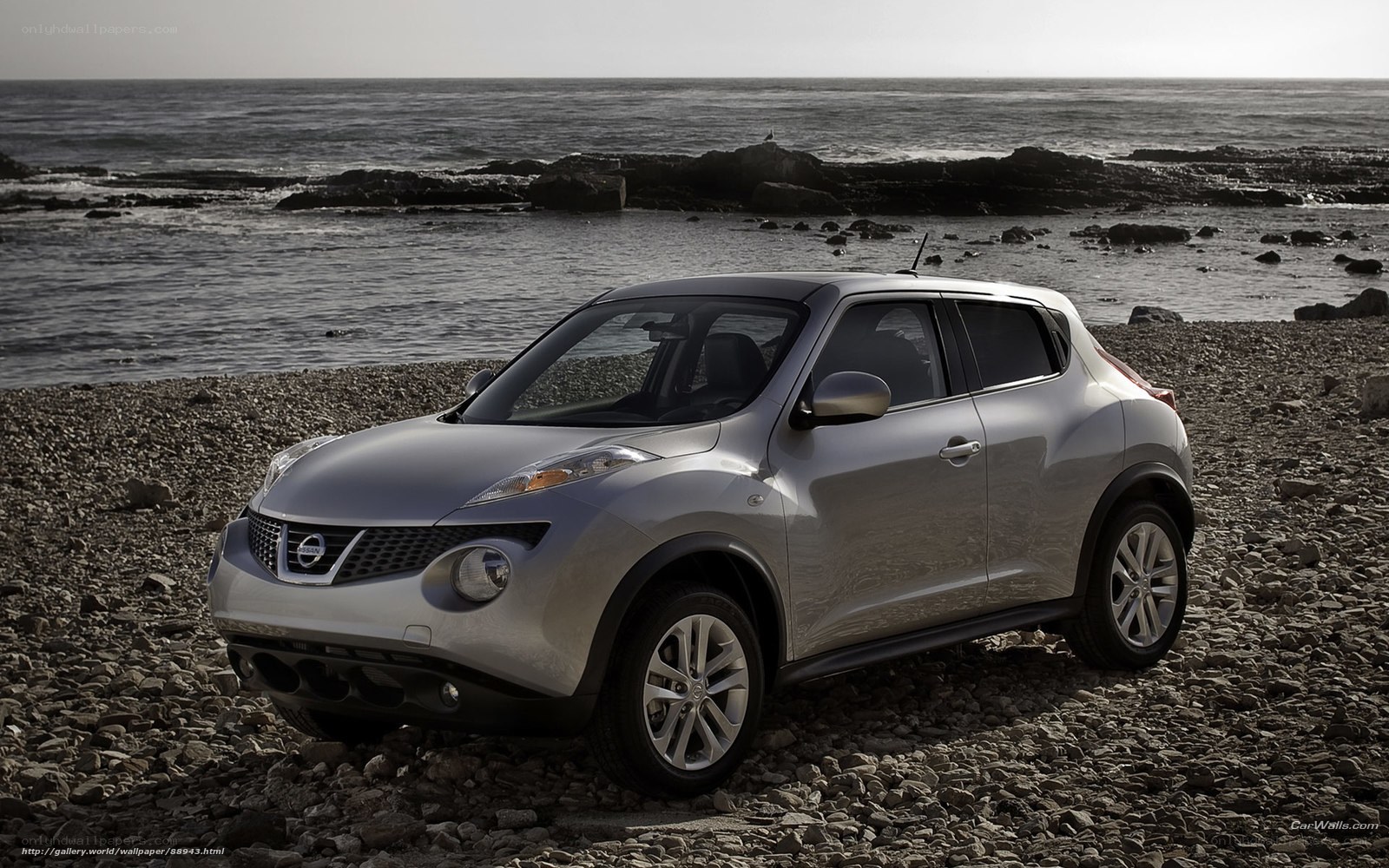 Silver Nissan Juke on a rocky beach