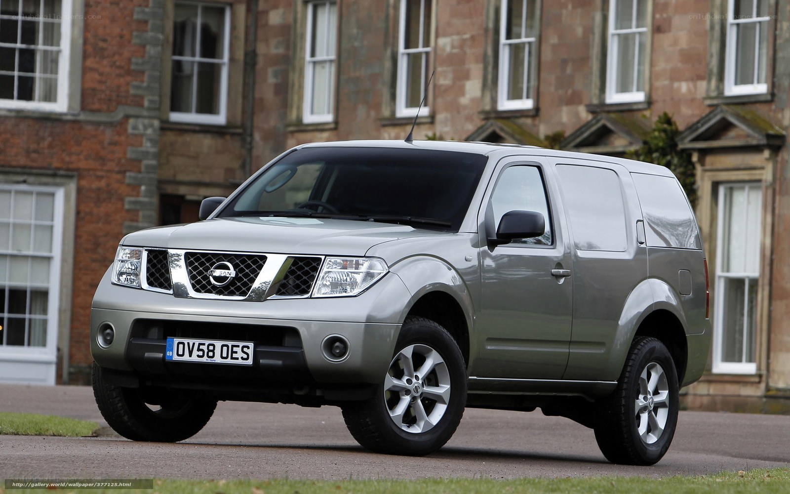 Silver Nissan Navara parked outside
