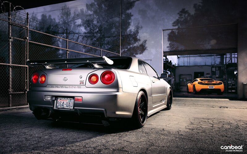 Silver Nissan Skyline and orange car