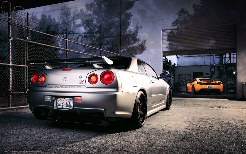 Silver Nissan Skyline and Orange Sports Car