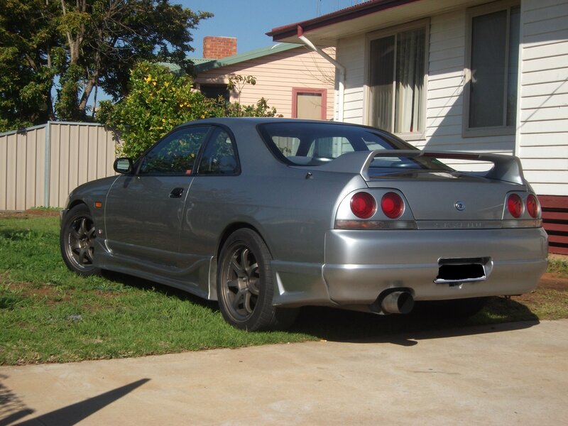 Silver Nissan Skyline parked outside