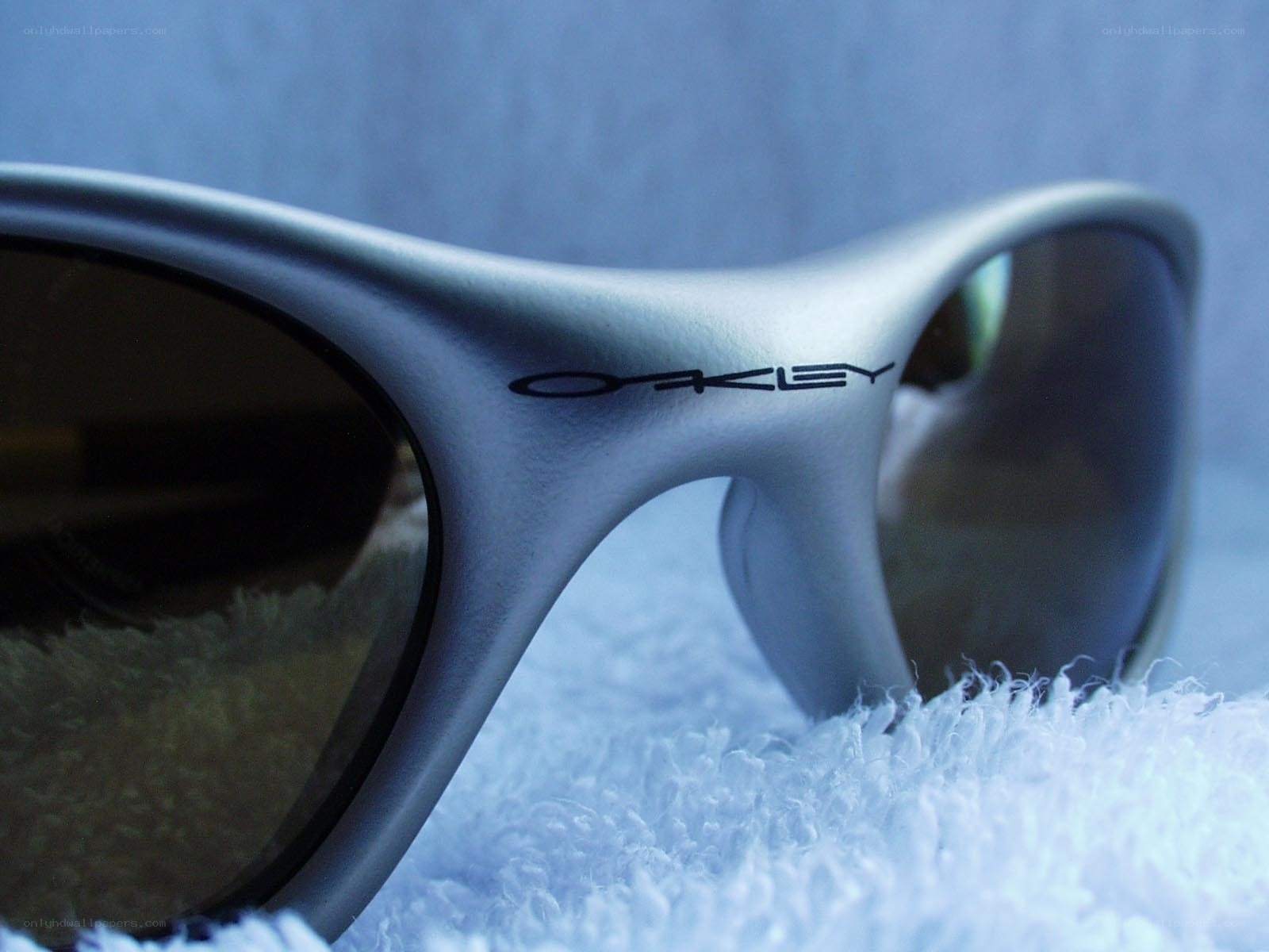 silver oakley sunglasses on towel