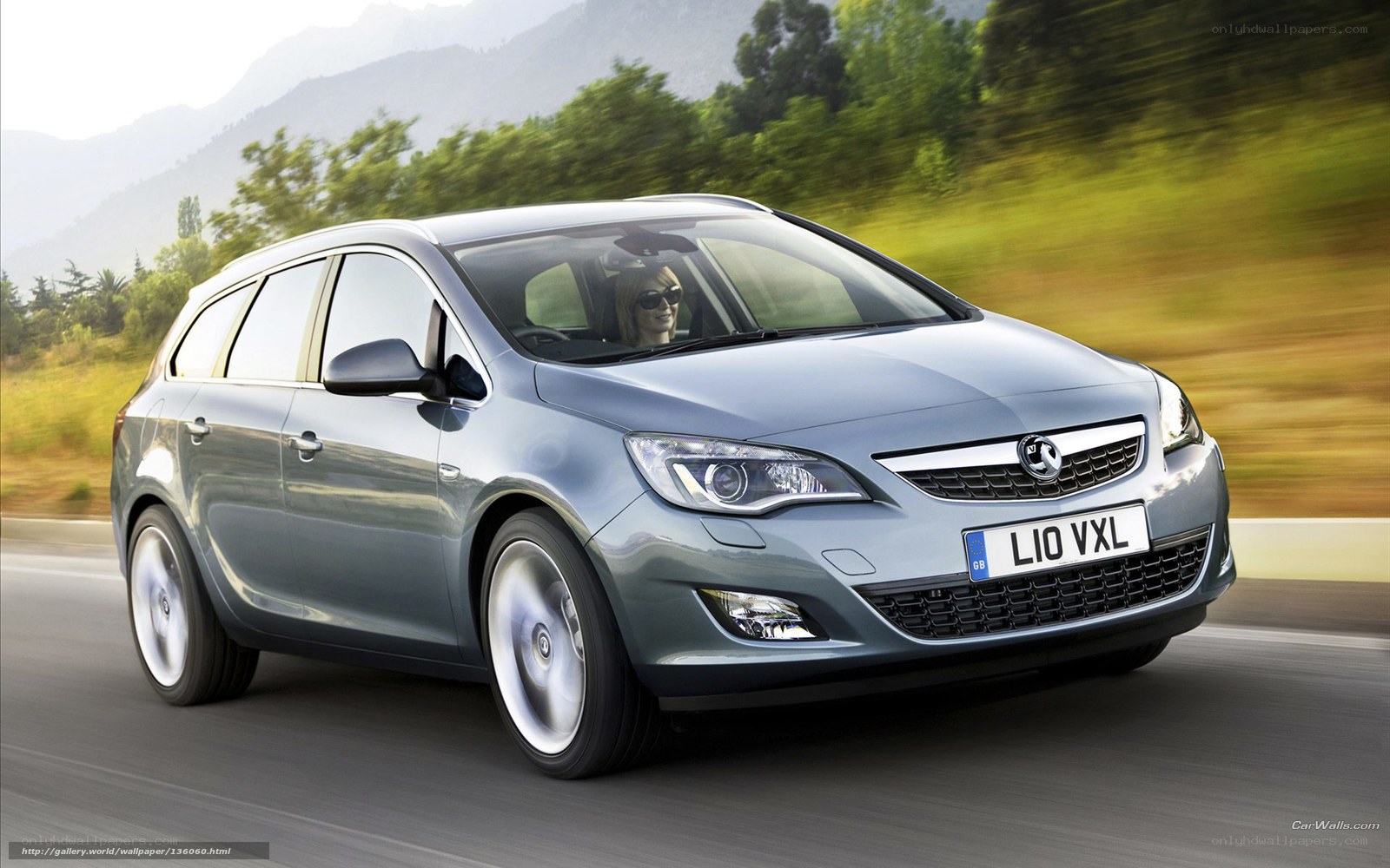 silver opel astra driving on road