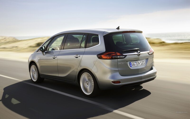 silver opel zafira driving on coastal road