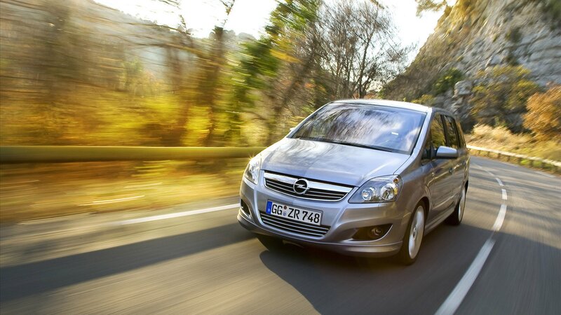 silver opel zafira driving on road