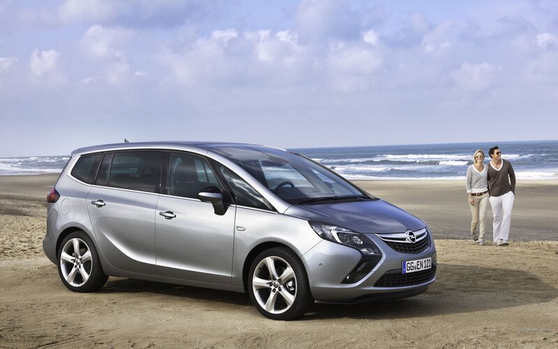 Silver Opel Zafira on the beach
