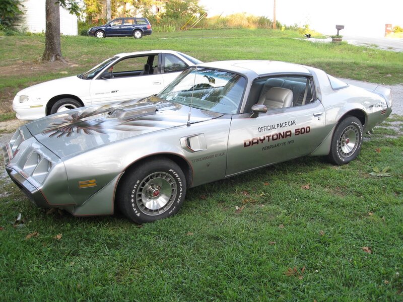 Silver pace car on grass