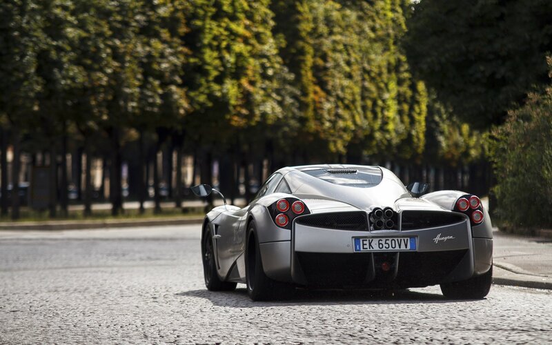 Silver Pagani Huayra on a tree-lined street