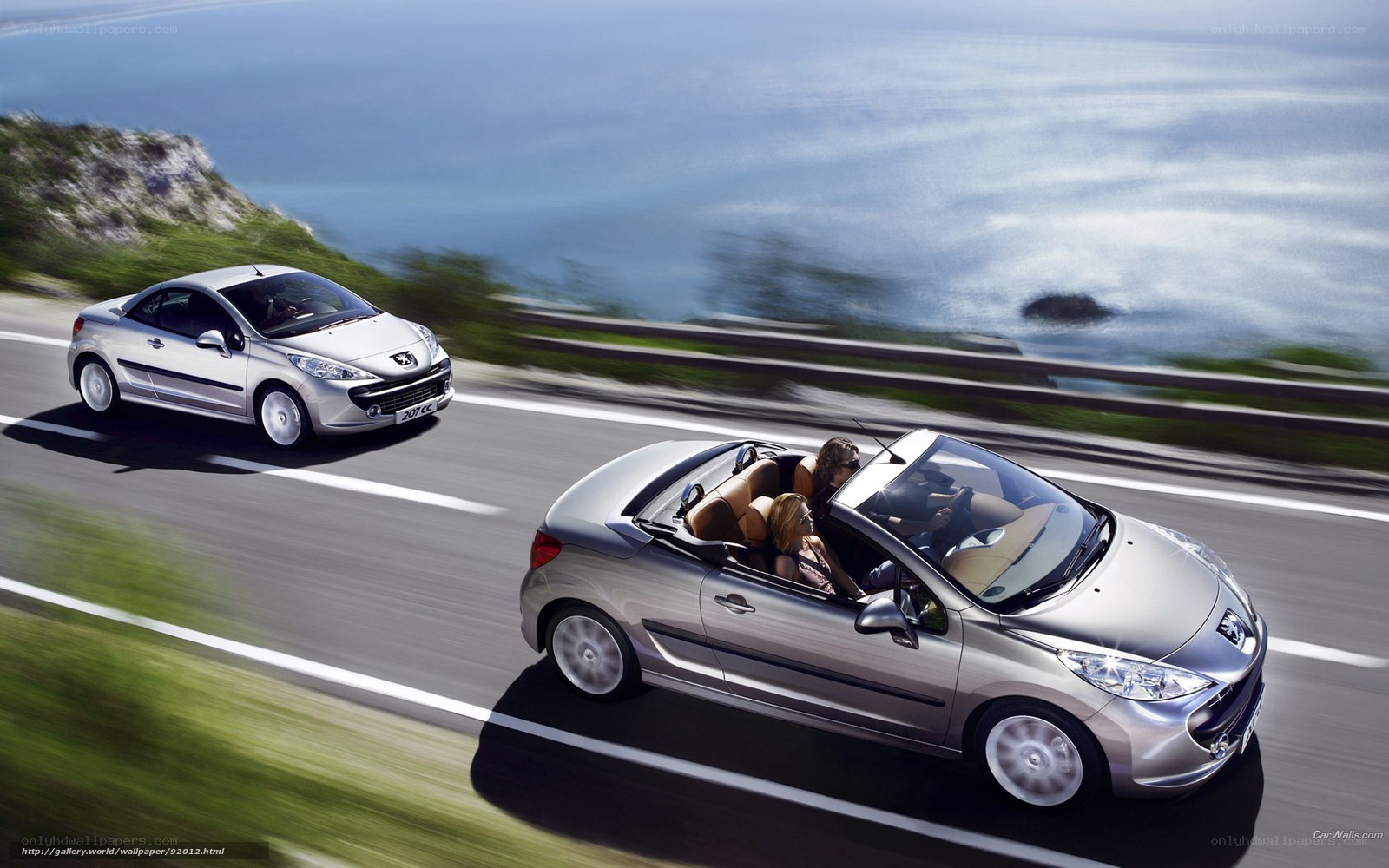 Silver Peugeot 207 on coastal road