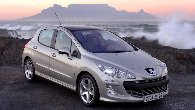 Silver Peugeot 308 by the coast