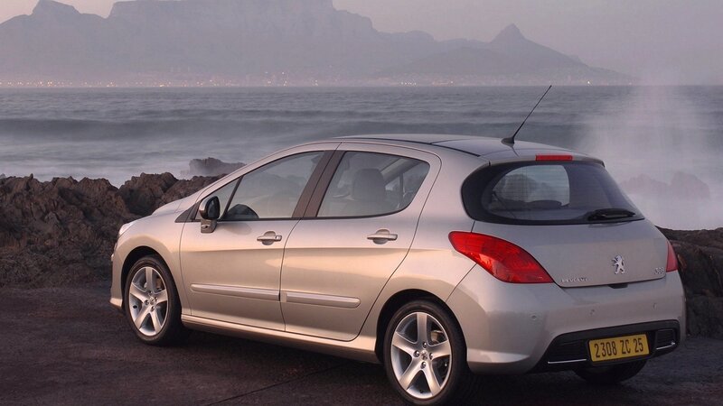 Silver Peugeot 308 by the sea