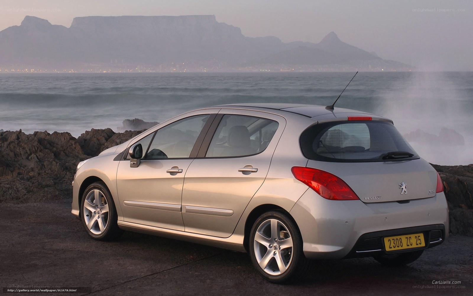 silver peugeot 308 by the sea