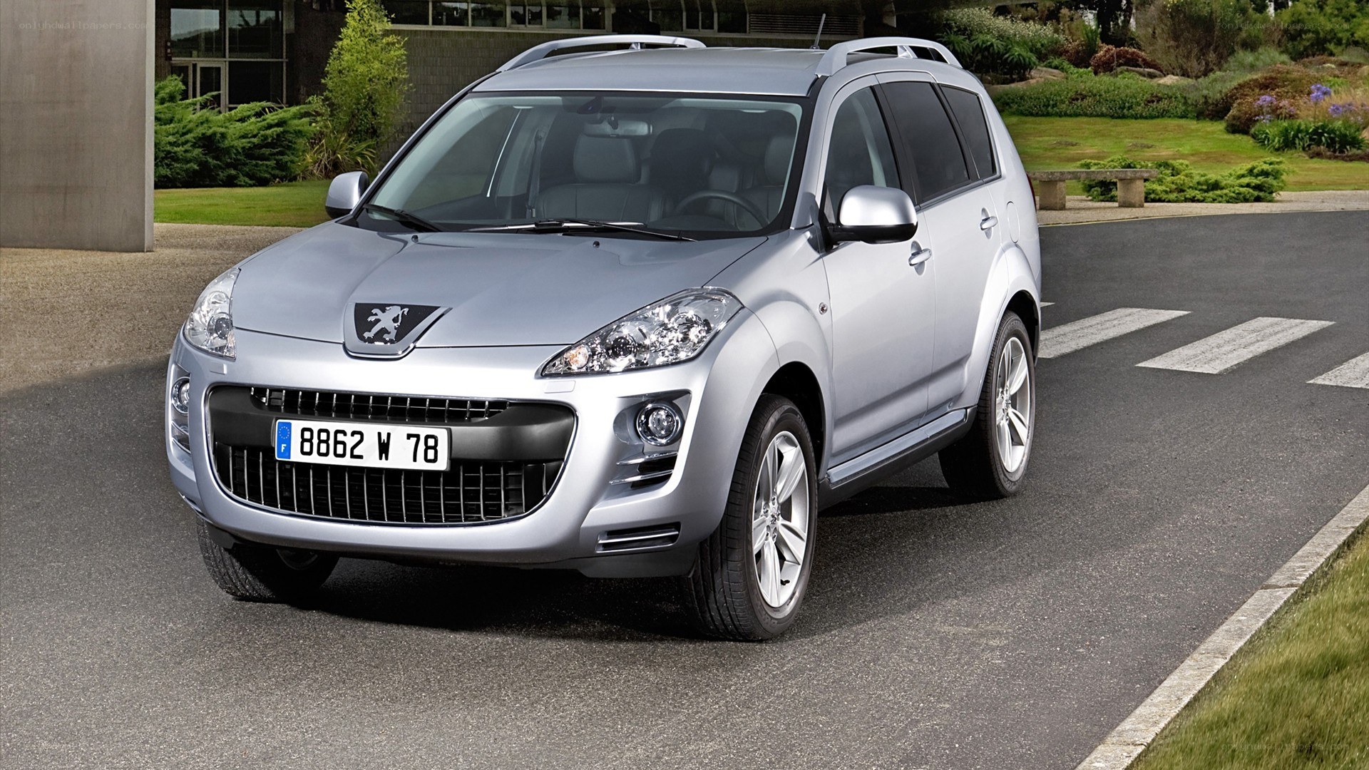 silver peugeot suv on road