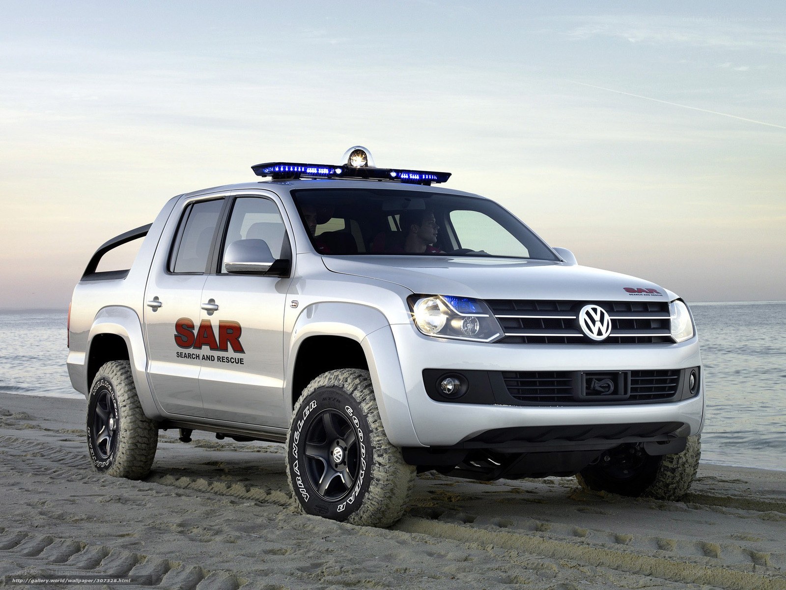 Silver pickup rescue vehicle on beach