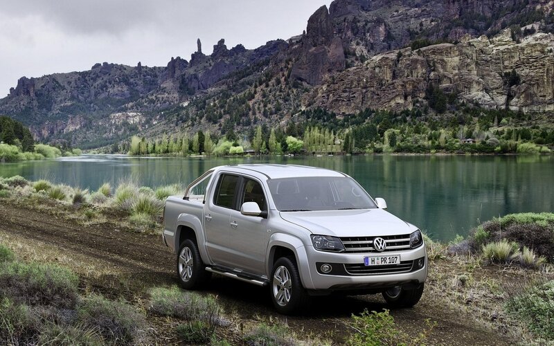 Silver pickup truck by a lake