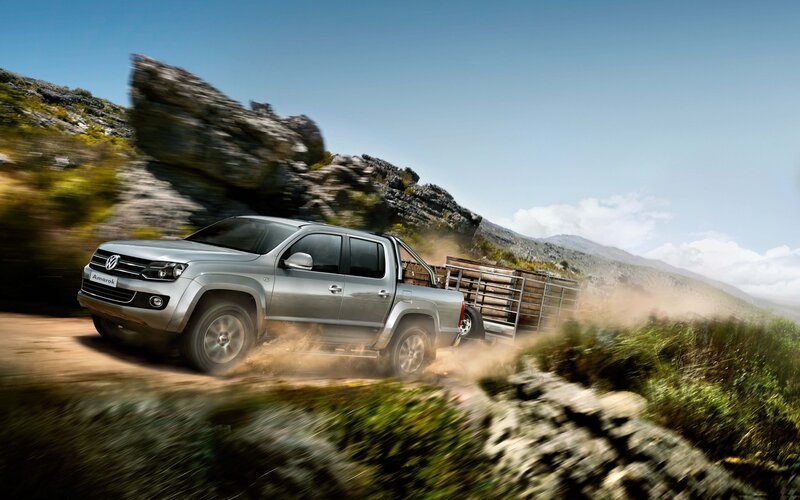Silver pickup truck on dirt road
