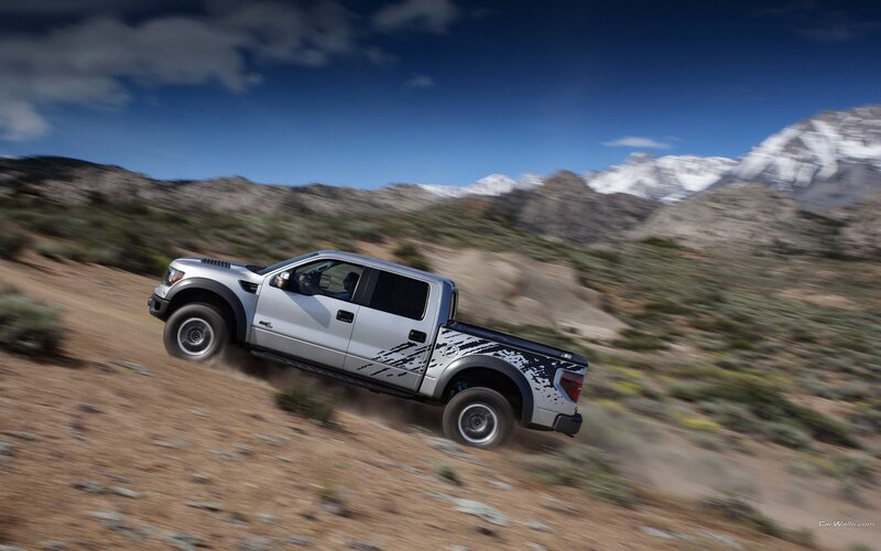 silver pickup truck on dirt road