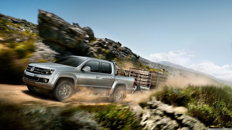 Silver pickup truck on dirt road