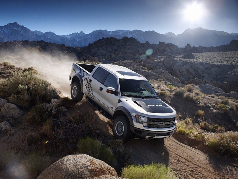 Silver pickup truck on dirt road
