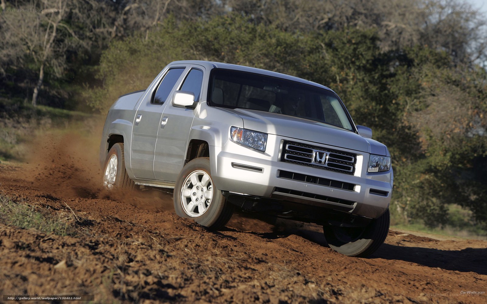 silver pickup truck on dirt road