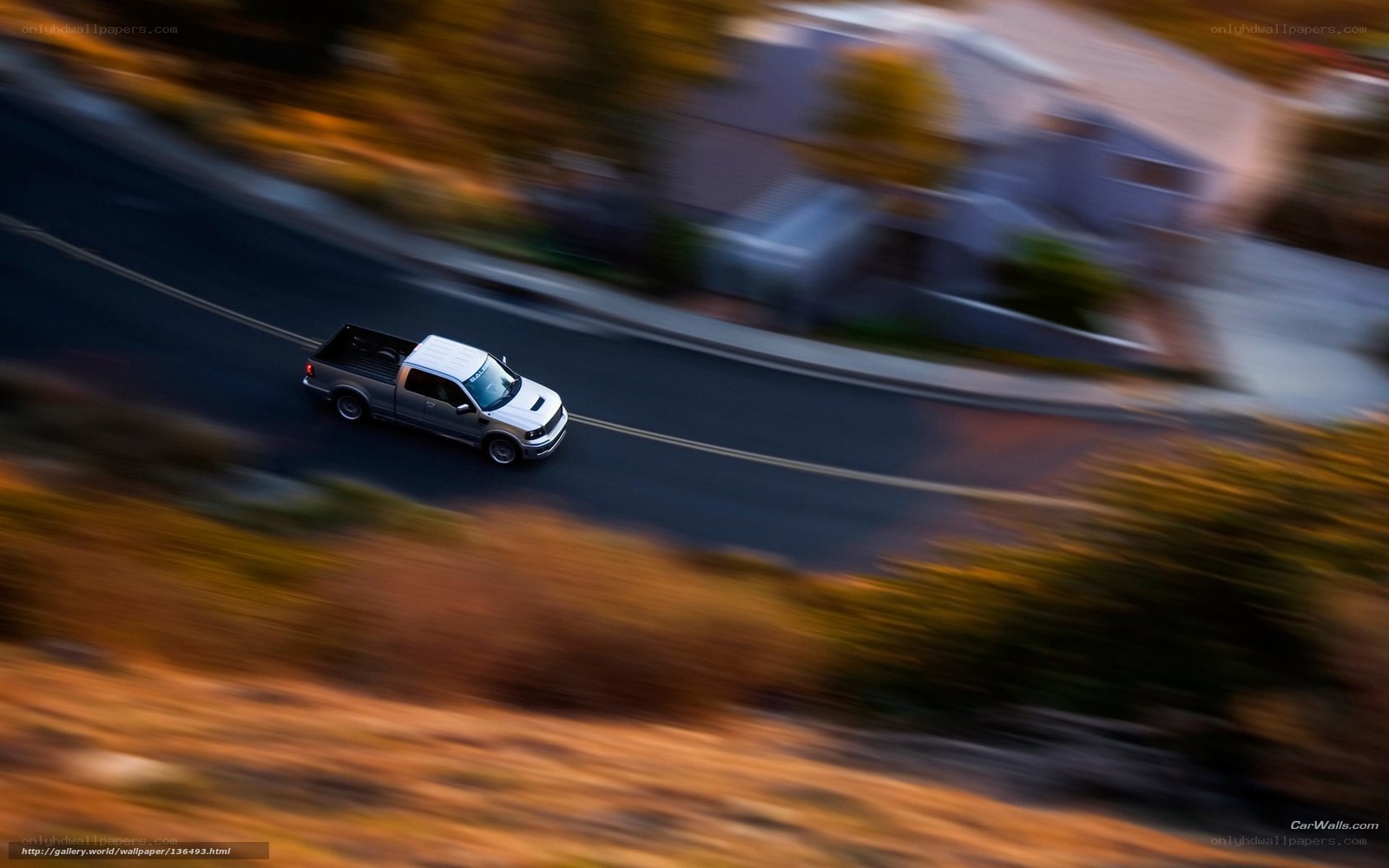 silver pickup truck on winding road