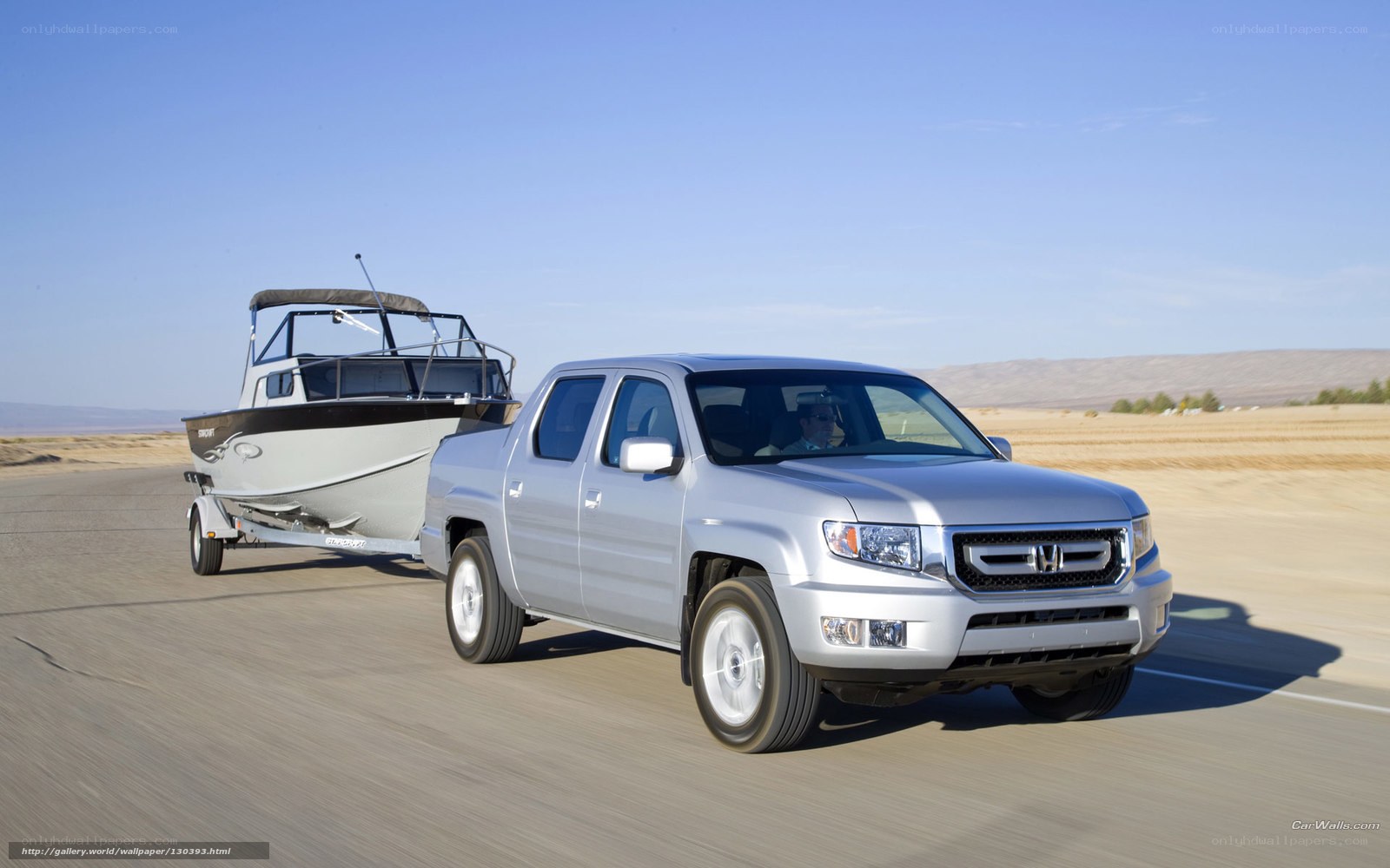 Silver pickup truck towing boat