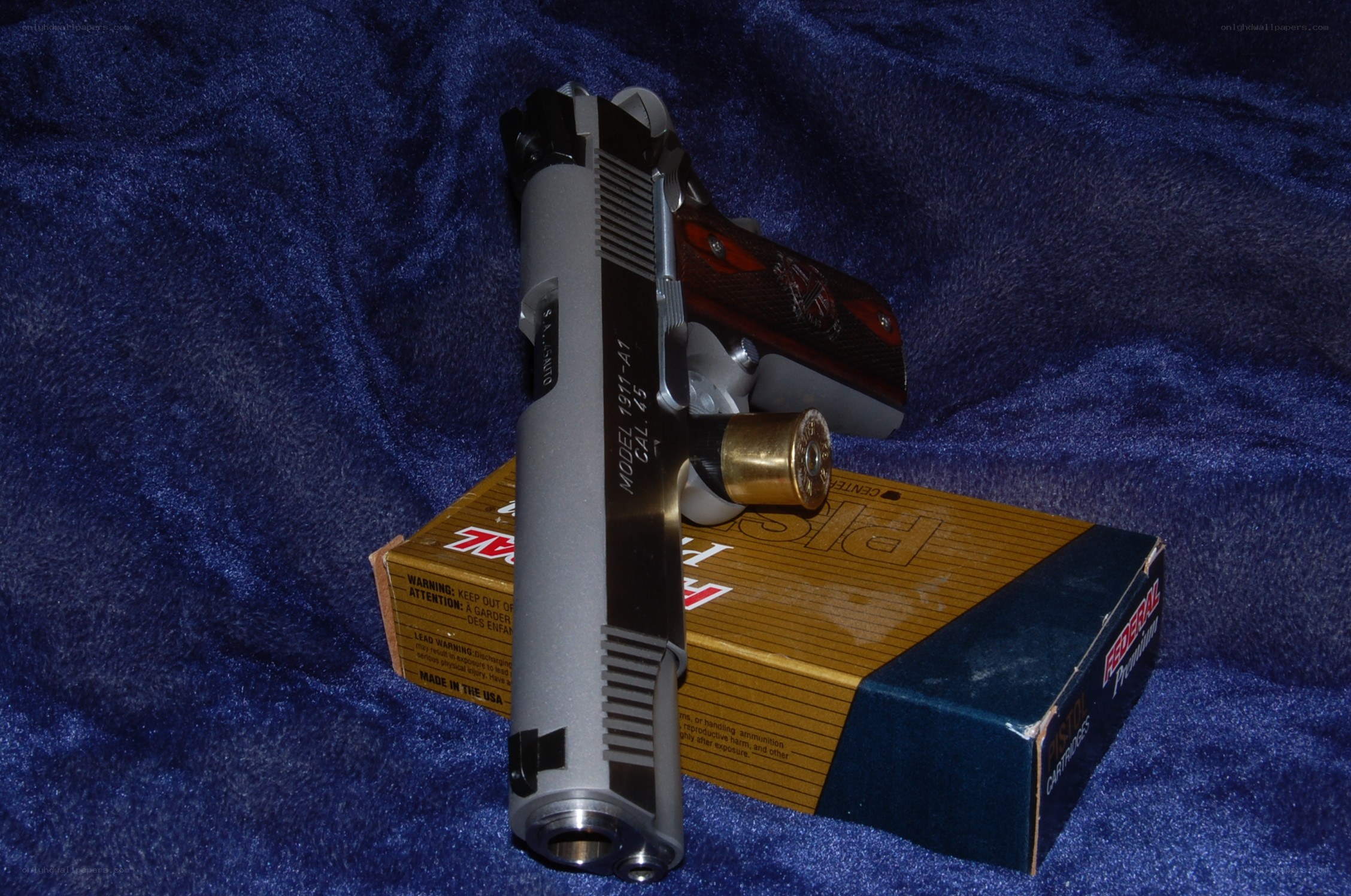 silver pistol on ammunition box