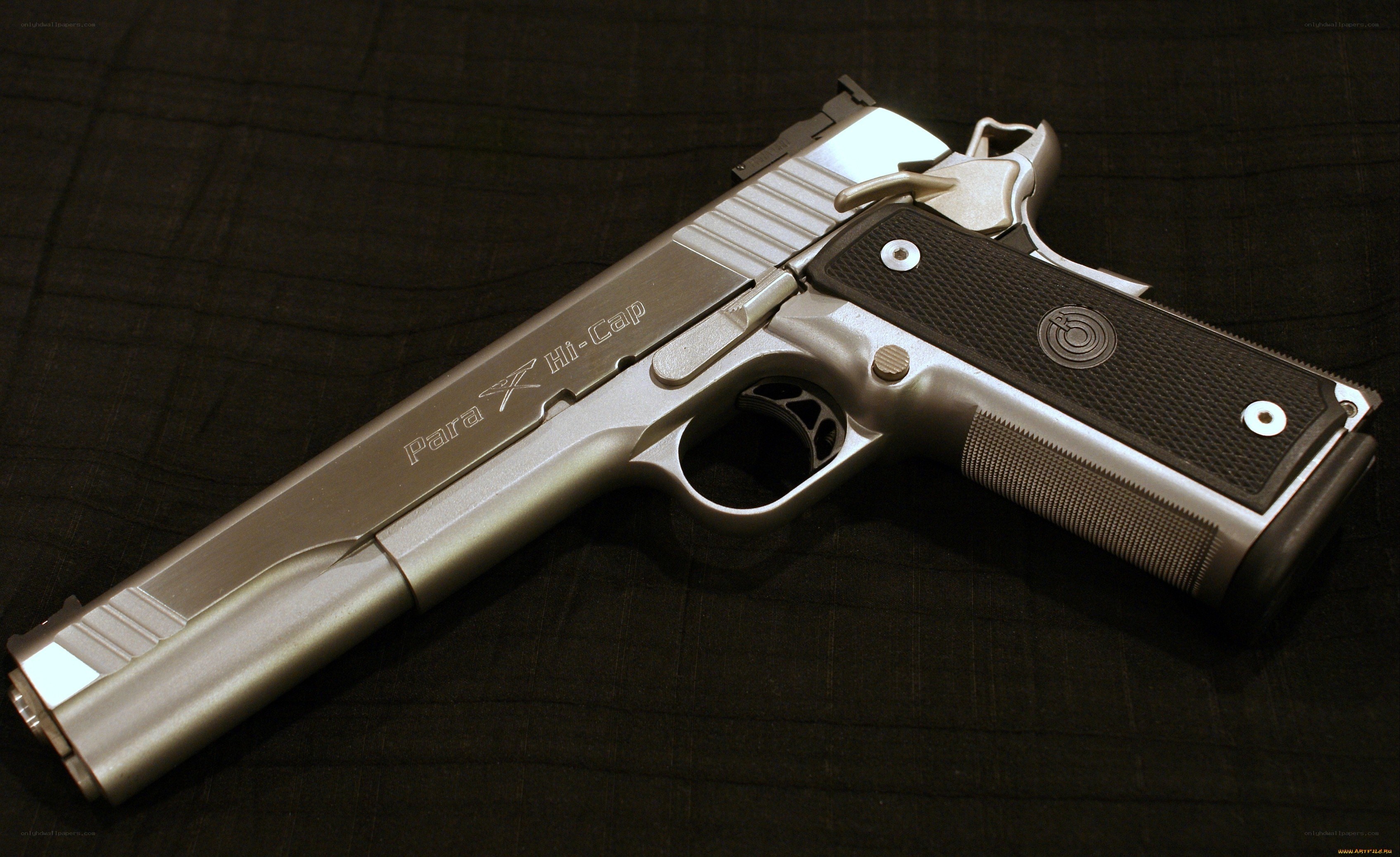 silver pistol on black fabric