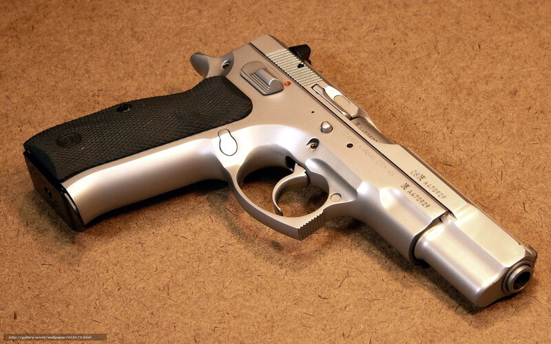 silver pistol on brown surface