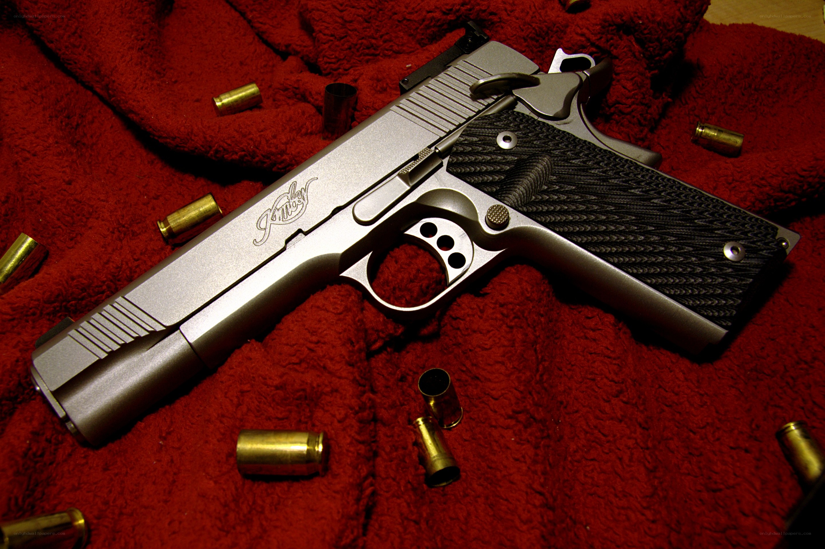silver pistol with bullet casings