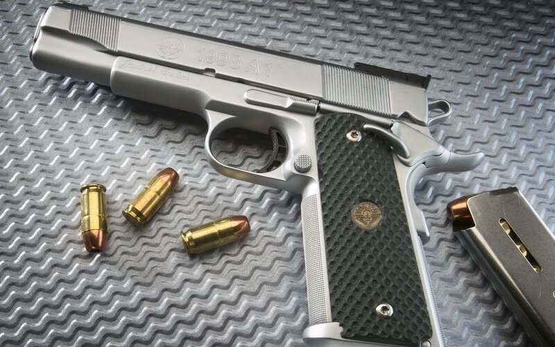 silver pistol with bullets