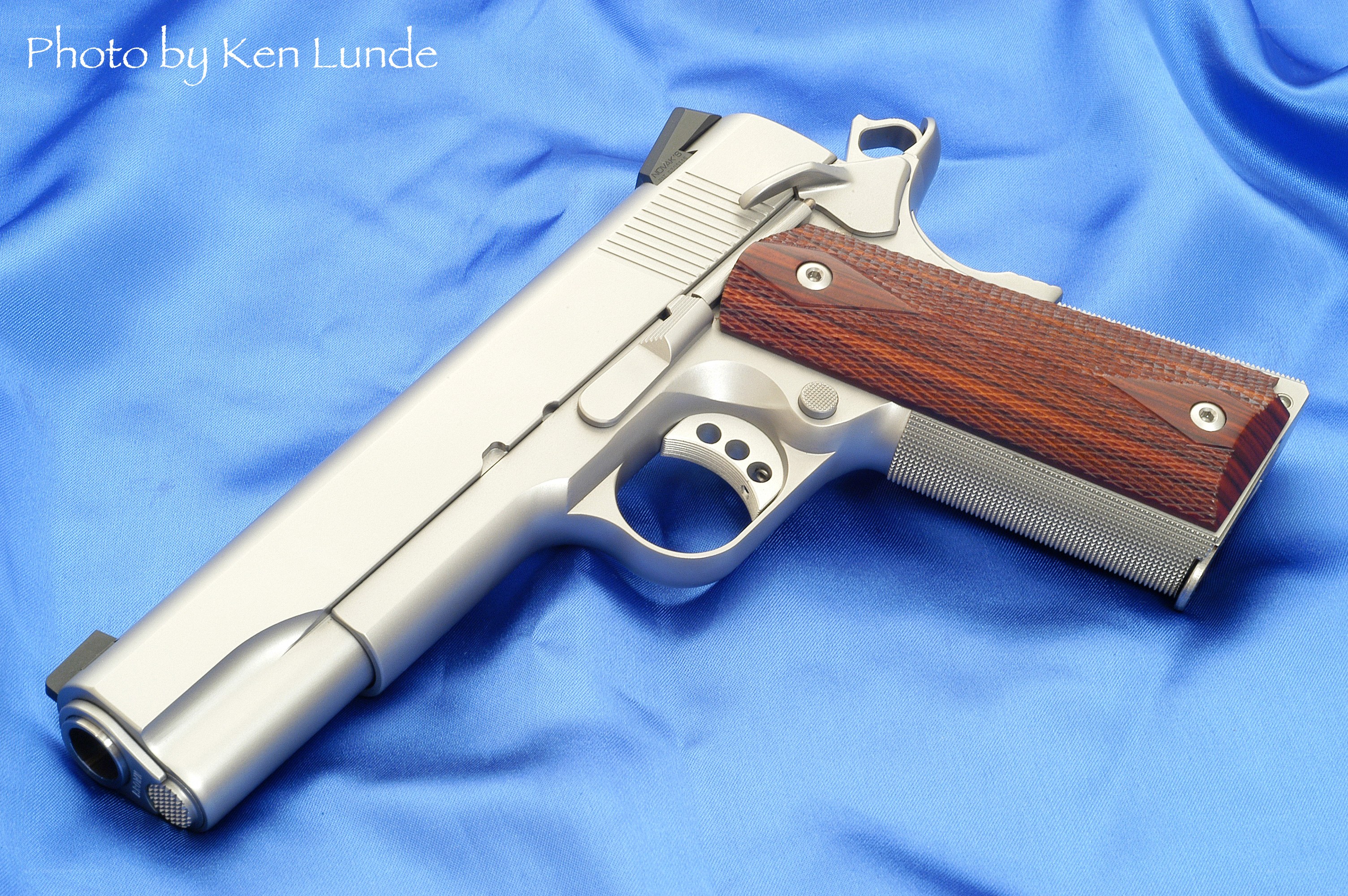 silver pistol with wood grips