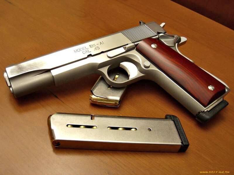 silver pistol with wooden grips