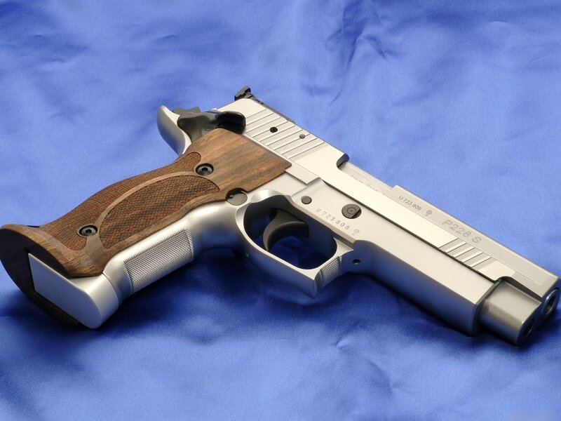 silver pistol with wooden grips