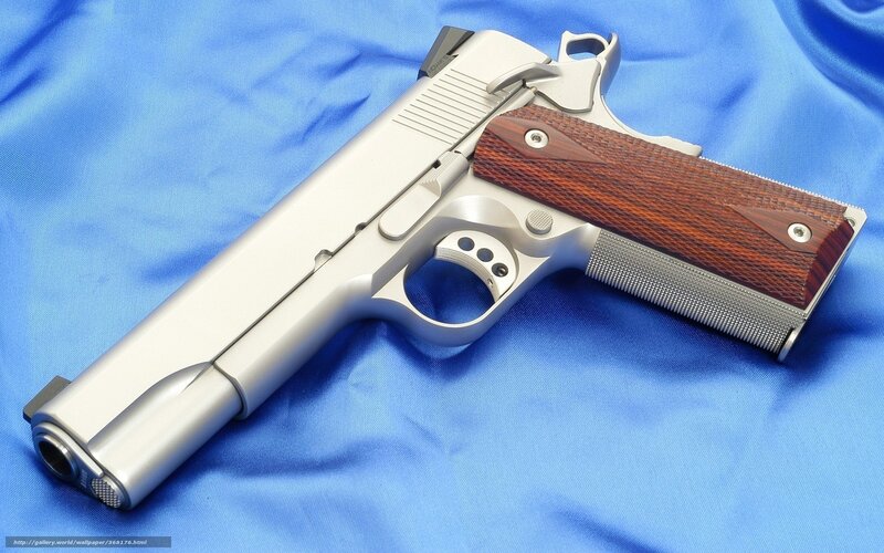 silver pistol with wooden grips