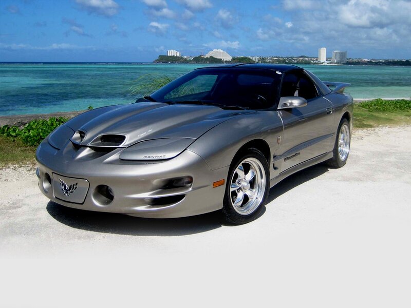 Silver Pontiac Firebird by the beach