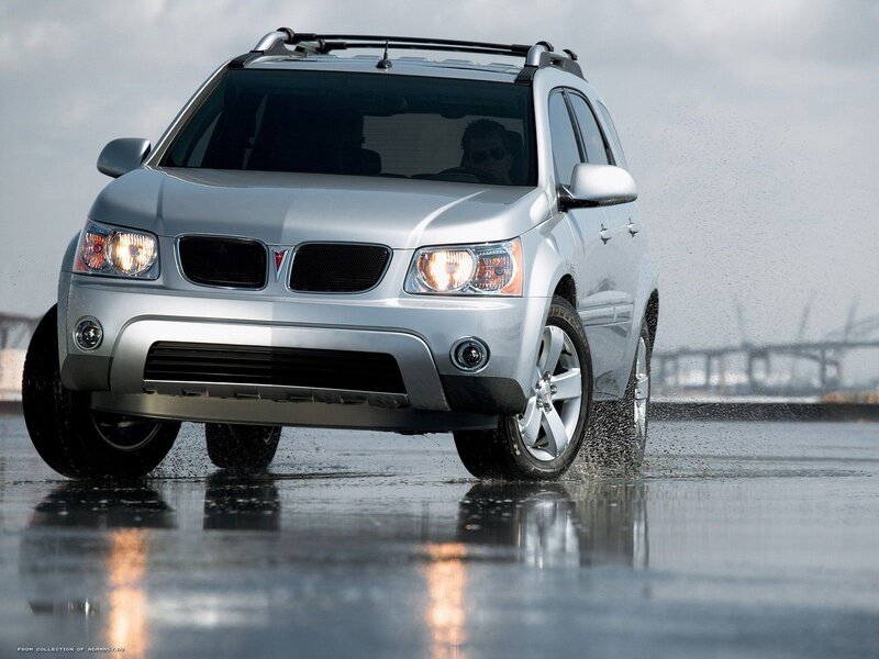 Silver Pontiac SUV driving on wet road