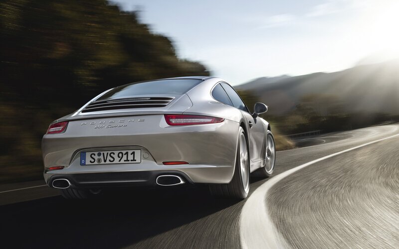 silver porsche 911 driving on road